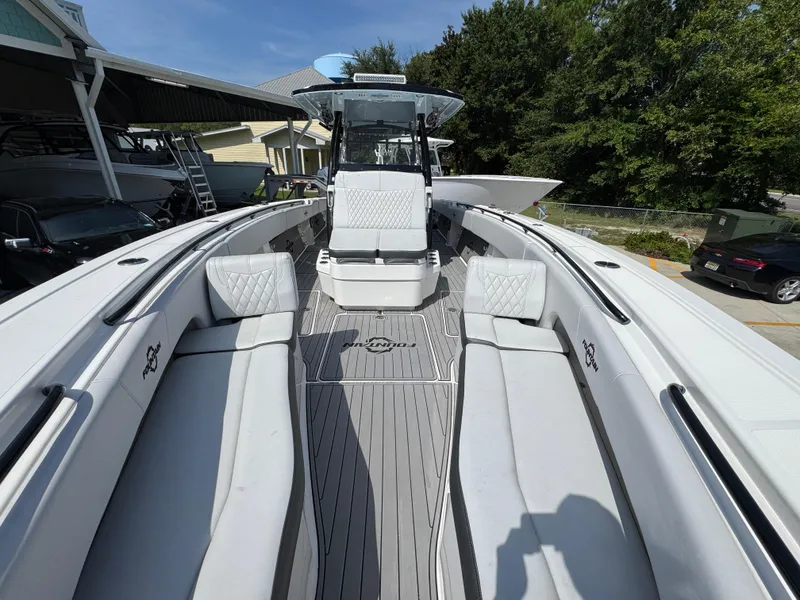 Slide: The Image of 2022 Fountain 38TE boat interior with white seating and sleek design. - 23