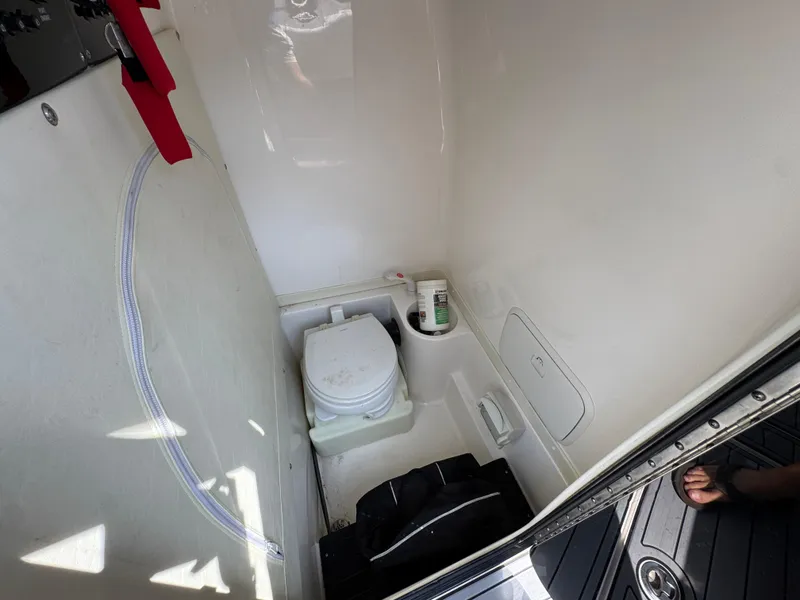 Slide: The Image of Compact bathroom in 2022 Fountain 38TE boat, featuring a toilet and storage space. - 26