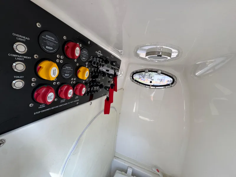 Slide: The Image of Control panel inside 2022 Fountain 38TE boat cabin with switches and buttons. - 27