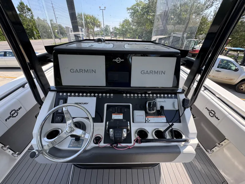 Slide: The Image of 2022 Fountain 38TE boat dashboard with Garmin navigation and Mercury controls. - 29