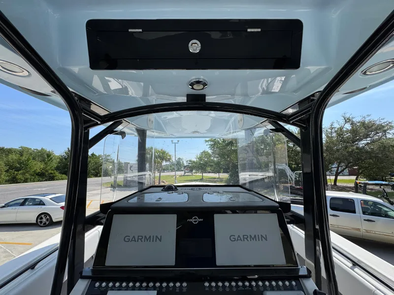 Slide: The Image of 2022 Fountain 38TE boat dashboard with dual Garmin displays and control panel. - 30