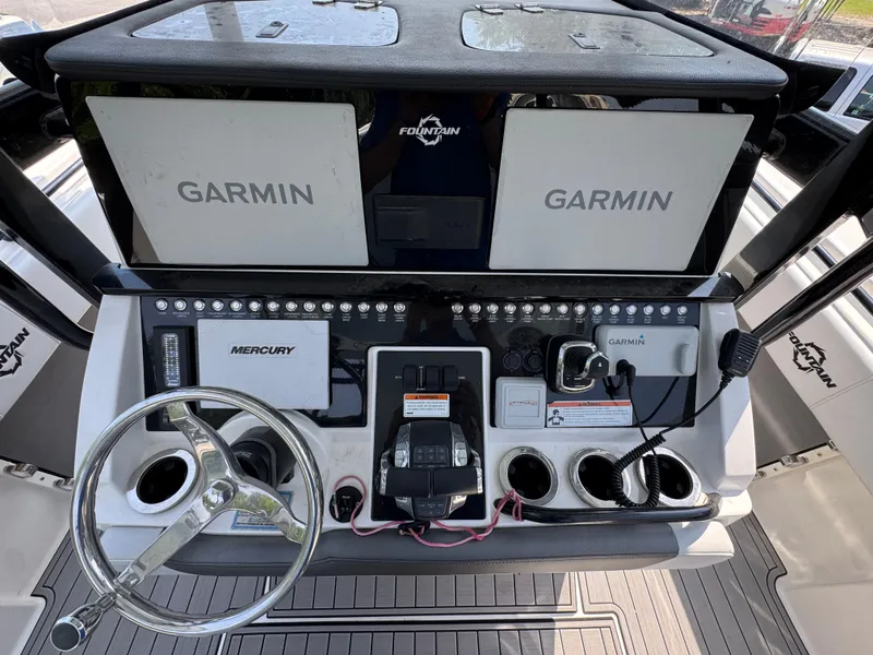 Slide: The Image of 2022 Fountain 38TE boat dashboard with Garmin displays and Mercury controls. - 31