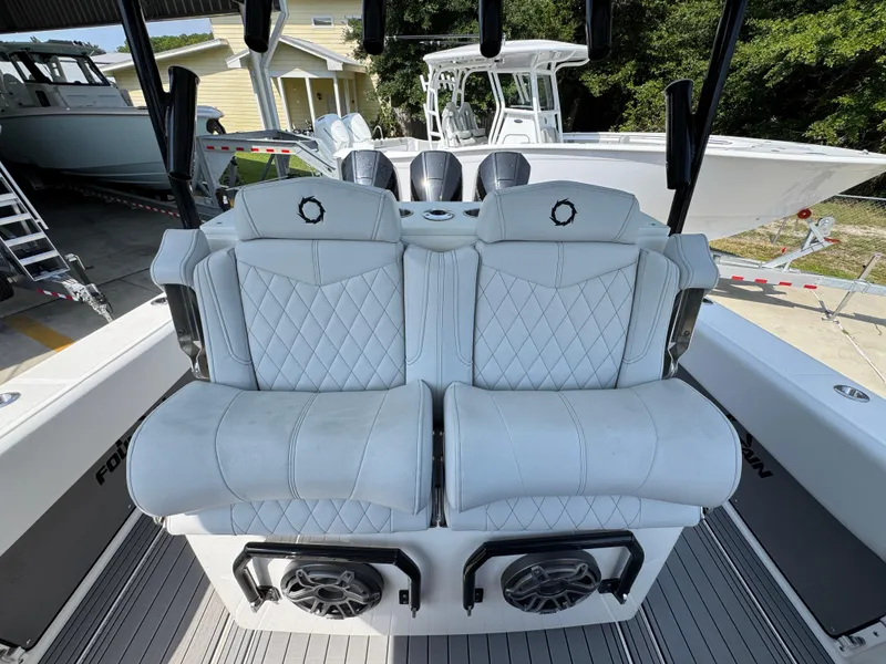 Slide: The Image of Luxury seating on a 2022 Fountain 38TE boat, featuring diamond-stitched upholstery. - 33