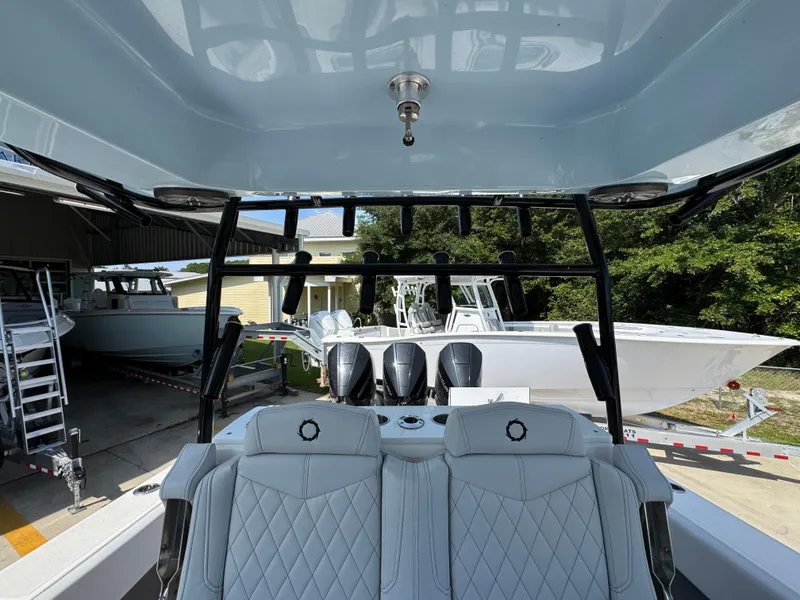 Slide: The Image of 2022 Fountain 38TE boat interior with luxurious seating and multiple outboard engines. - 34