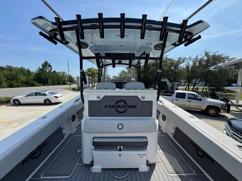 Slide: The Image of 2022 Fountain 38TE boat interior with seating and storage, parked in a lot. - 36