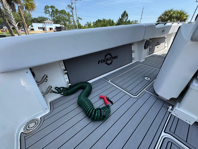 Slide: The Image of 2022 Fountain 38TE boat deck with coiled green hose and sleek design. - 37