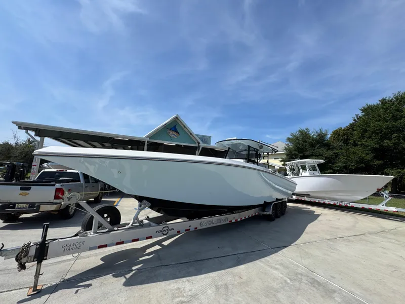 Slide: The Image of 2022 Fountain 38TE boat on trailer under clear blue sky. - 4