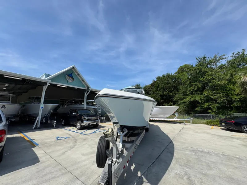 Slide: The Image of 2022 Fountain 38TE boat on trailer at dealership under clear blue sky. - 6