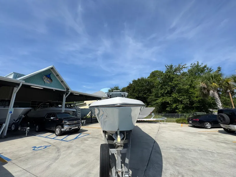 Slide: The Image of 2022 Fountain 38TE boat on trailer in parking lot under clear blue sky. - 7