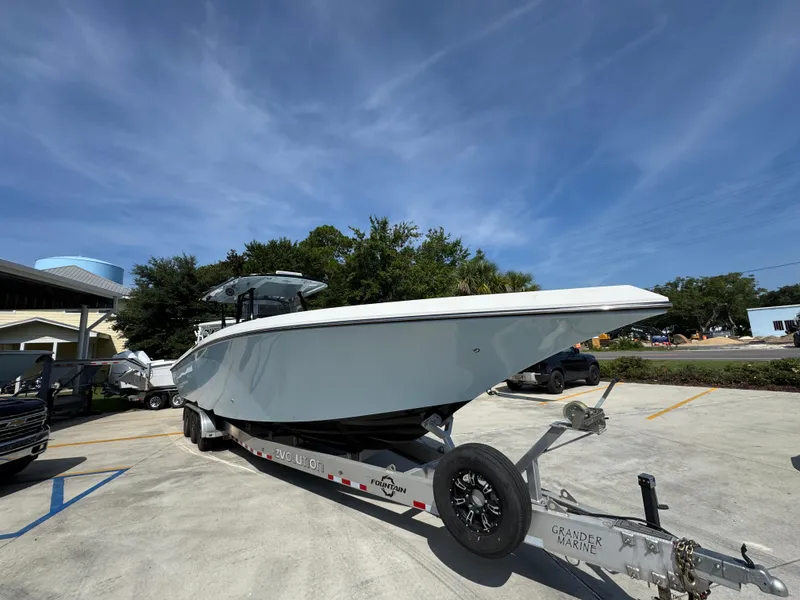 Slide: The Image of 2022 Fountain 38TE boat on trailer in parking lot under clear blue sky. - 8