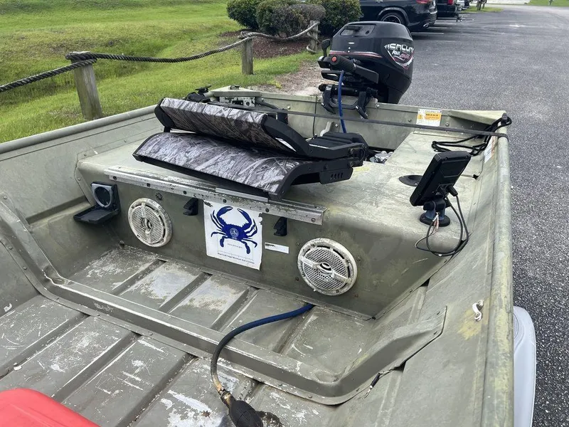 Slide: The Image of 2010 Triton 14' Jon boat with motor, speakers, and crab decal on deck. - 10