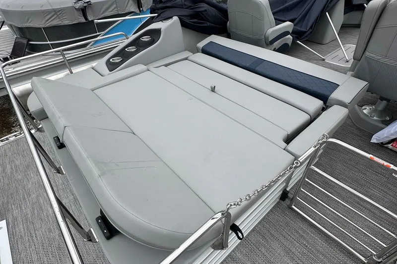 Slide: The Image of 2024 Bennington L 23 Swingback boat interior with gray seating and cup holders. - 10