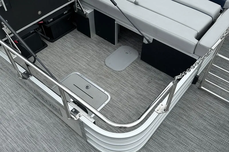 Slide: The Image of 2024 Bennington L 23 Swingback boat interior with seating and storage compartments. - 9