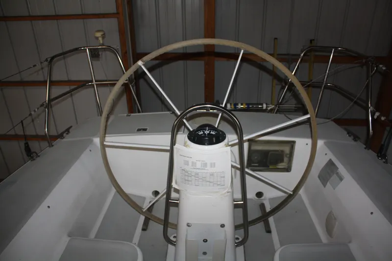 Slide: The Image of 2002 J Boats J/105 sailboat cockpit with steering wheel and navigation instruments. - 17