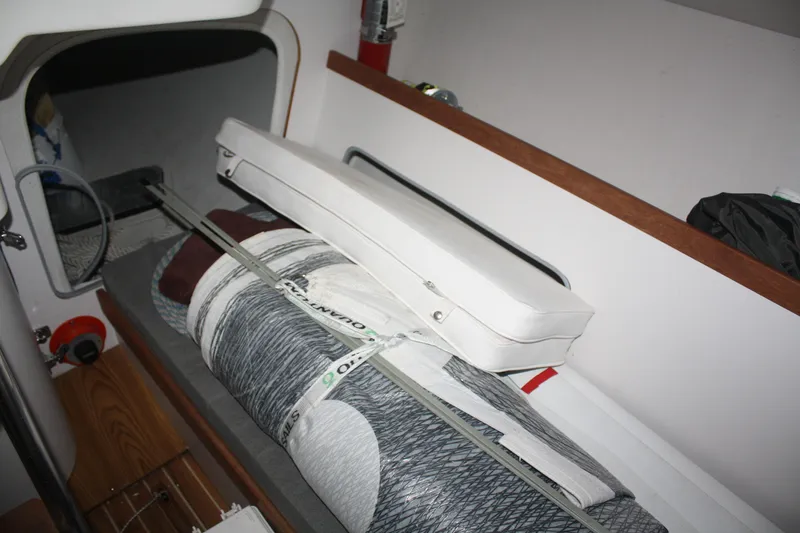 Slide: The Image of Interior of a 2002 J Boats J/105 sailboat showing stored sails and equipment. - 26