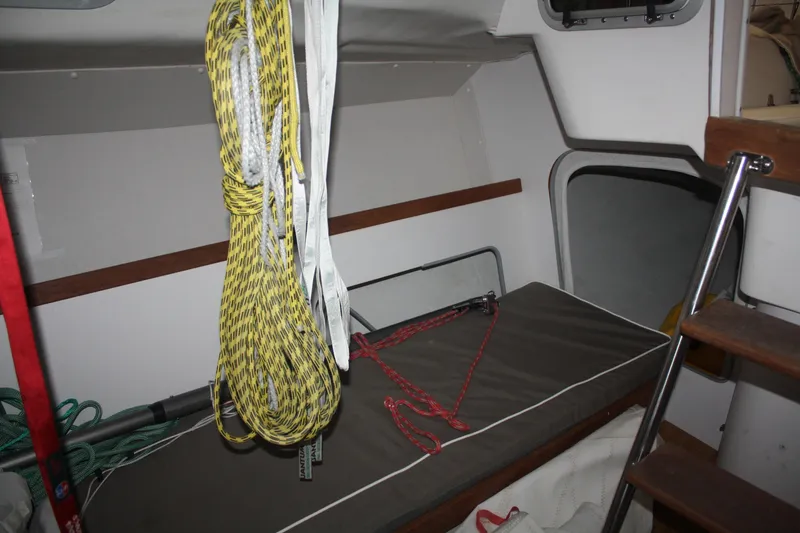 Slide: The Image of Interior of a 2002 J Boats J/105 sailboat with ropes and storage area. - 30