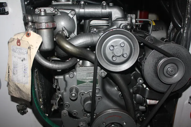 Slide: The Image of Engine of a 2002 J Boats J/105 sailboat, featuring belts and hoses. - 39