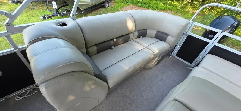 Slide: The Image of 2021 Sun Tracker 22 Party Barge RF interior with plush seating and cup holder. - 10