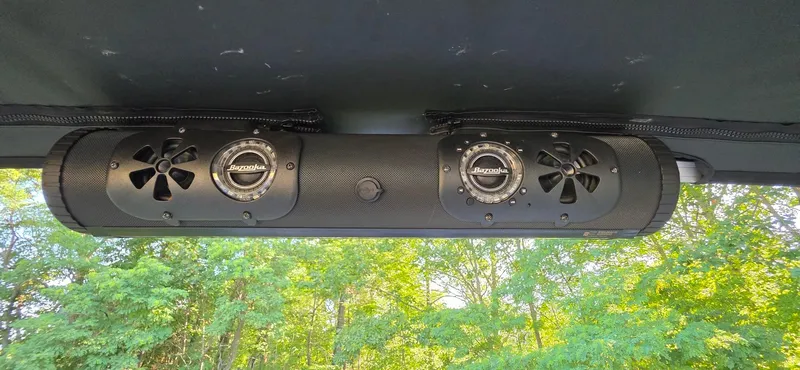 Slide: The Image of Bazooka sound system on 2021 Sun Tracker 22 Party Barge RF, surrounded by lush greenery. - 14