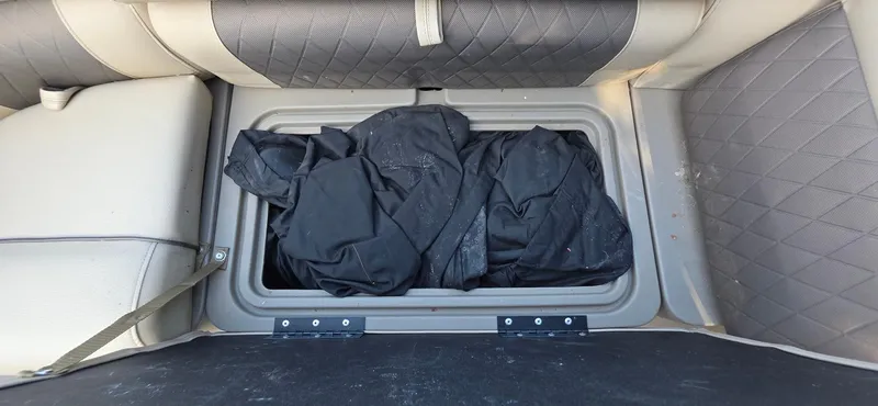 Slide: The Image of Storage compartment in 2021 Sun Tracker 22 Party Barge RF with black fabric inside. - 17