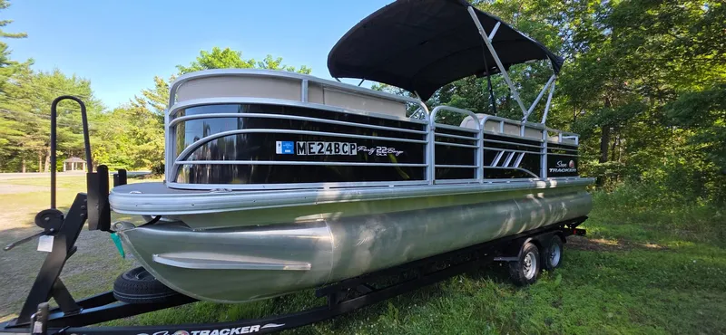Slide: The Image of 2021 Sun Tracker 22 Party Barge RF pontoon boat on a trailer in a wooded area. - 20
