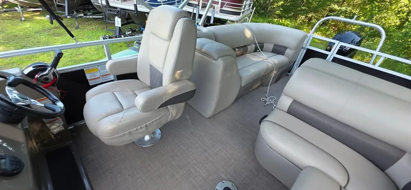 Slide: The Image of 2021 Sun Tracker 22 Party Barge RF interior with plush seating and steering console. - 6