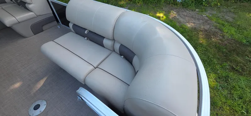 Slide: The Image of 2021 Sun Tracker 22 Party Barge RF with beige seating, outdoor setting. - 7