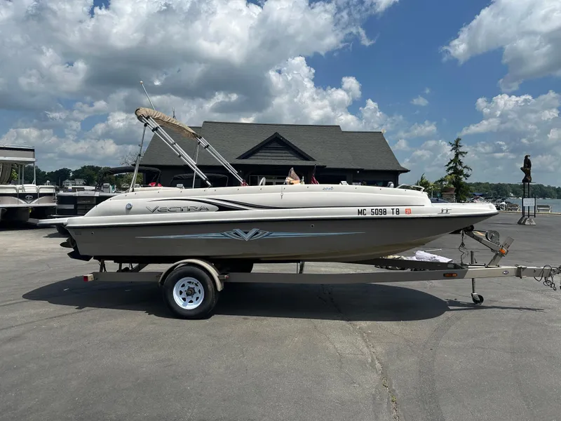 Slide: The Image of 2007 Smoker Craft Vectra 2040 boat on trailer, parked outdoors under cloudy sky. - 0