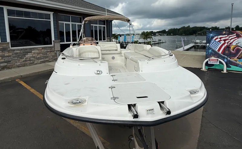Slide: The Image of 2007 Smoker Craft Vectra 2040 boat docked near a lakeside building. - 4