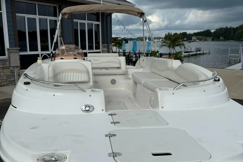 Slide: The Image of 2007 Smoker Craft Vectra 2040 boat with spacious seating, docked by a scenic lakeside. - 6