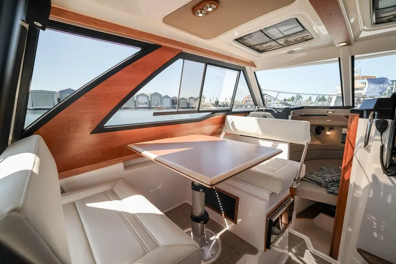 Slide: The Image of Interior of 2026 Cutwater C-248 Coupe, featuring elegant seating and dining area. - 4