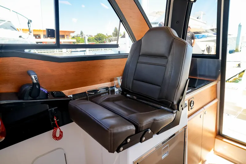 Slide: The Image of 2026 Cutwater C-248 Coupe interior with leather captain's chair and wooden accents. - 9