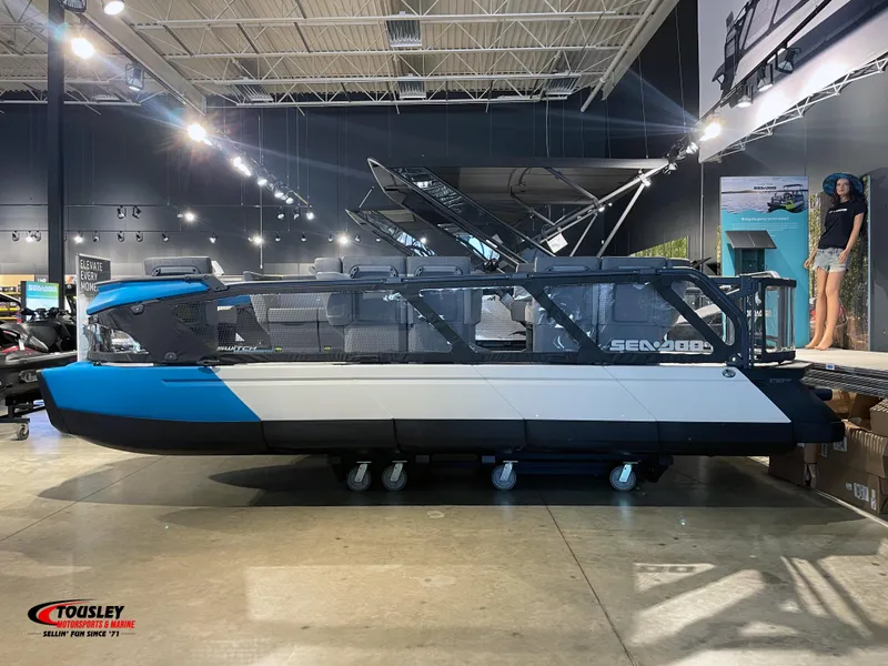 Slide: The Image of 2023 Sea-Doo Switch 19 - 170 HP pontoon boat displayed in showroom. - 1
