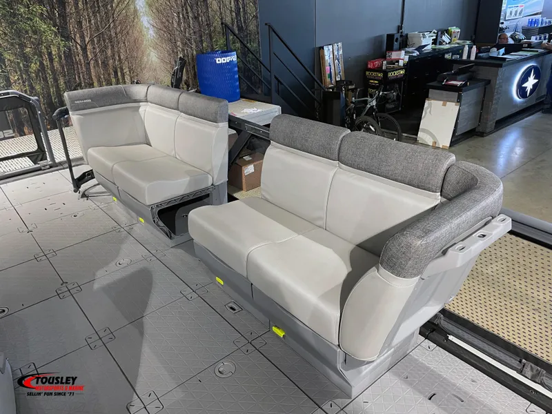 Slide: The Image of 2023 Sea-Doo Switch 19 interior seating, featuring gray cushioned benches in a showroom setting. - 2