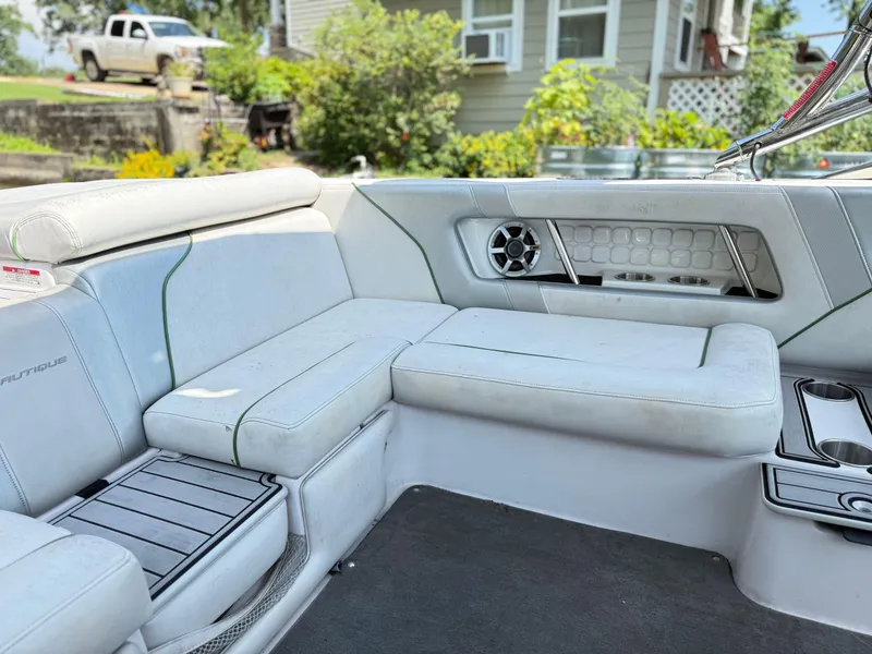 Slide: The Image of 2008 Nautique Super Air 230 interior with white seating and speaker system. - 10