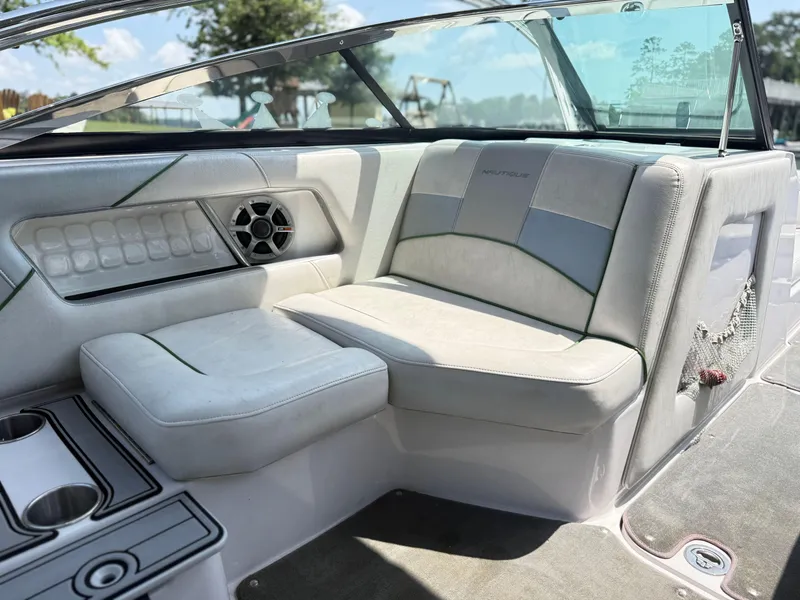 Slide: The Image of 2008 Nautique Super Air 230 interior with cushioned seating and speaker system. - 15