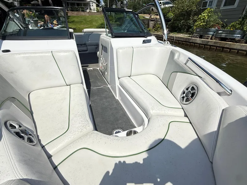 Slide: The Image of 2008 Nautique Super Air 230 boat interior with white seating and speakers. - 17
