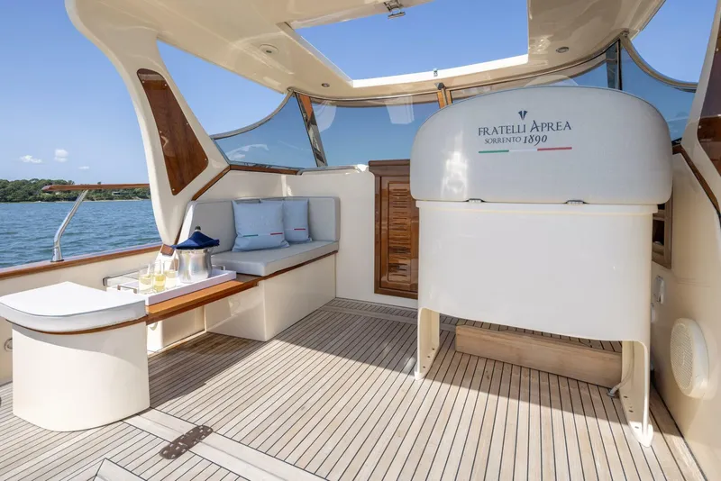 Slide: The Image of Luxurious 2022 Fratelli Aprea 32 Hard Top yacht interior with elegant seating and wooden accents. - 10