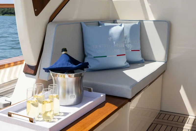 Slide: The Image of Luxurious seating area on 2022 Fratelli Aprea 32 Hard Top yacht with champagne. - 11