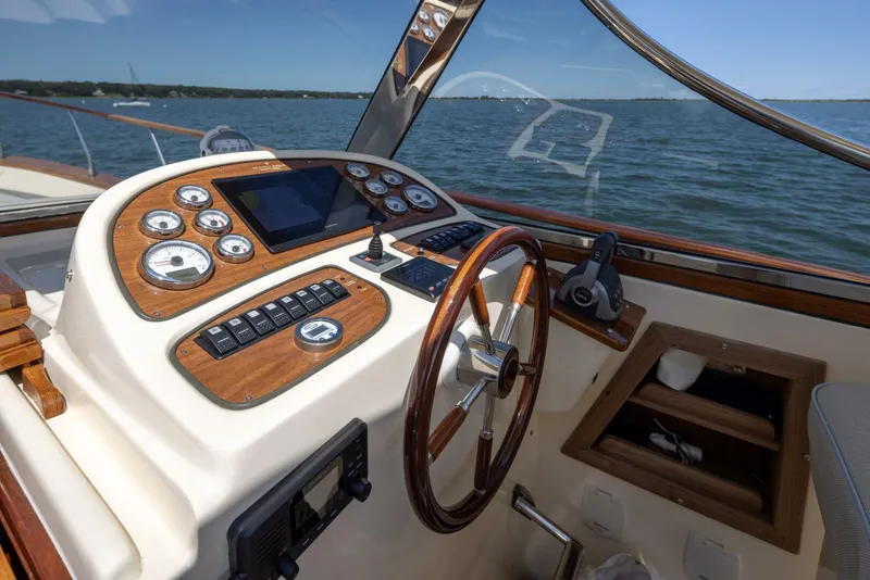 Slide: The Image of Fratelli Aprea 32 Hard Top 2022 boat helm with wooden dashboard and steering wheel. - 13