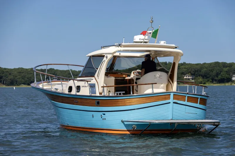 Slide: The Image of 2022 Fratelli Aprea 32 Hard Top boat on water, featuring elegant design and vibrant blue hull. - 6