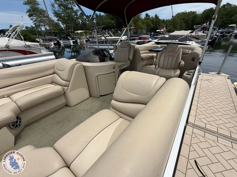 Slide: The Image of 2014 Bennington 2250 GSR pontoon boat with beige seating, docked at a marina. - 12