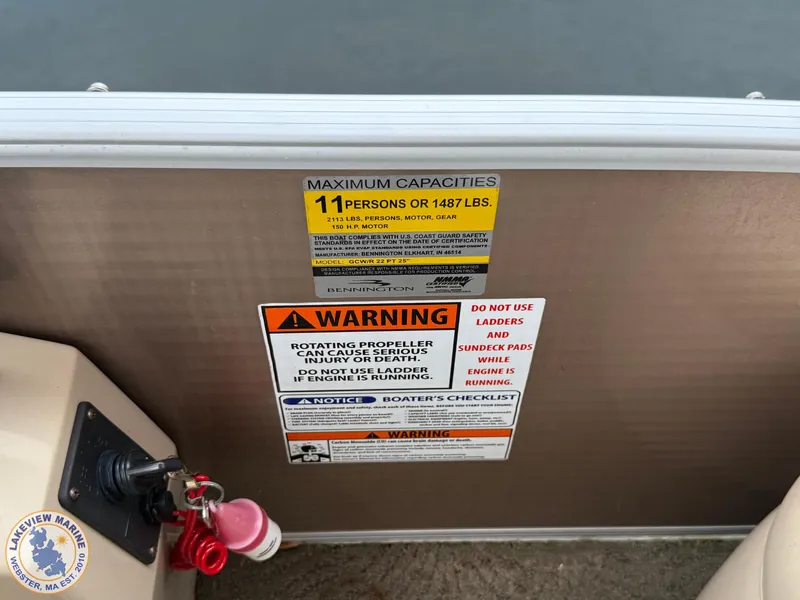 Slide: The Image of 2014 Bennington 2250 GSR boat capacity and safety warning labels. - 13