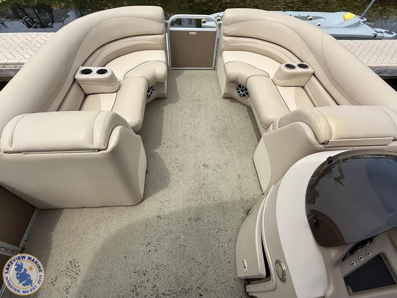 Slide: The Image of 2014 Bennington 2250 GSR boat interior with beige seating and cup holders. - 4