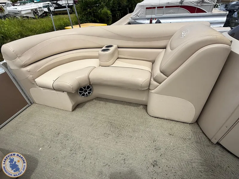 Slide: The Image of 2014 Bennington 2250 GSR boat interior with beige seating and cup holders. - 5