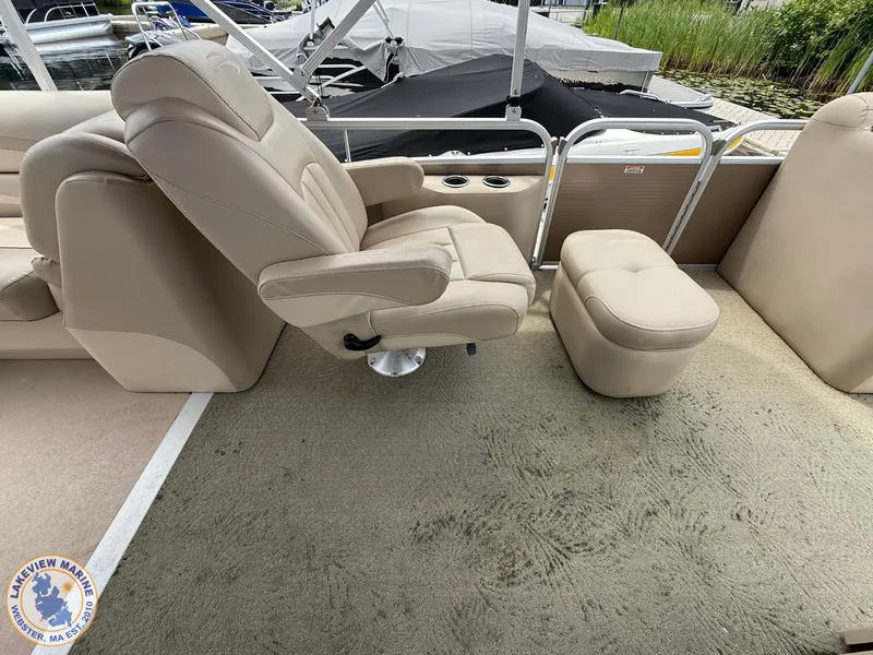 Slide: The Image of 2014 Bennington 2250 GSR boat interior with beige seating and carpeted floor. - 9