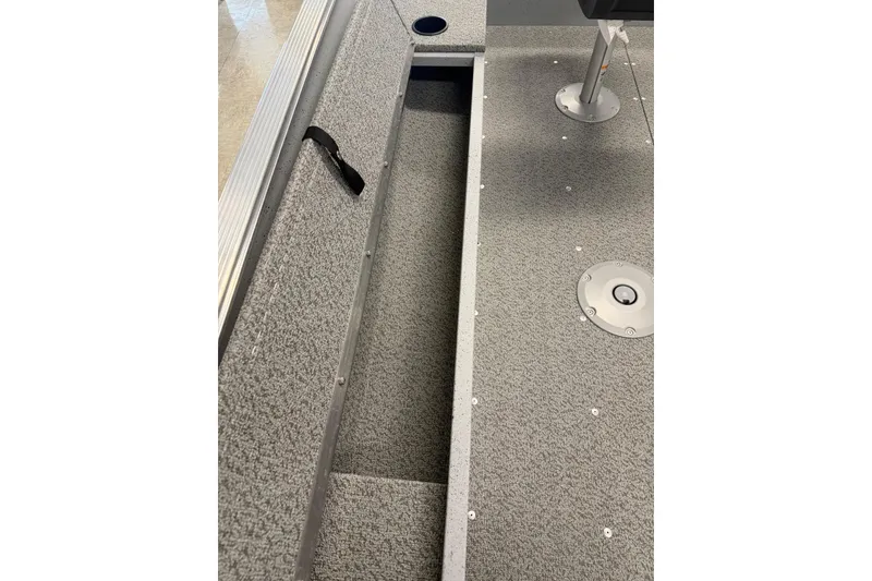 Slide: The Image of 2026 Lund 1600 Fury Tiller boat interior with storage compartment and seating. - 11