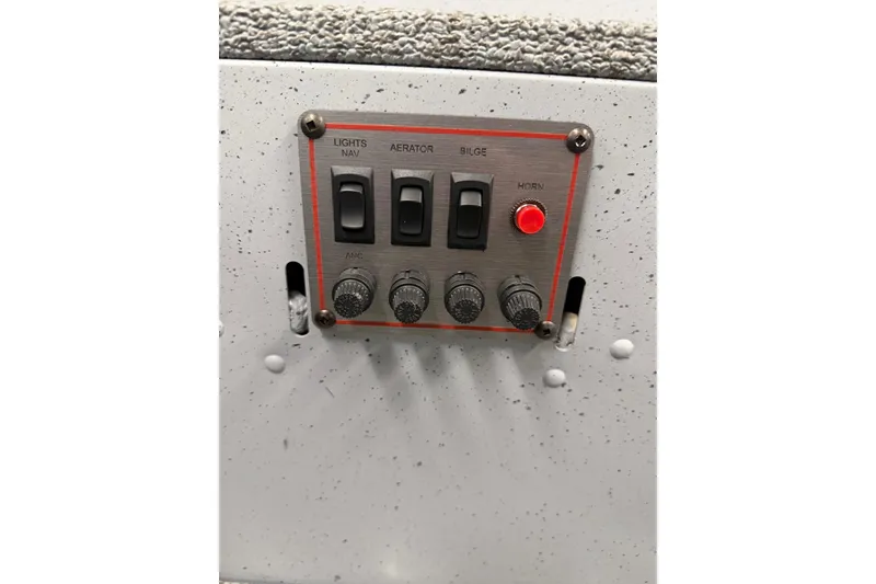 Slide: The Image of Control panel of 2026 Lund 1600 Fury Tiller boat with switches and knobs. - 13