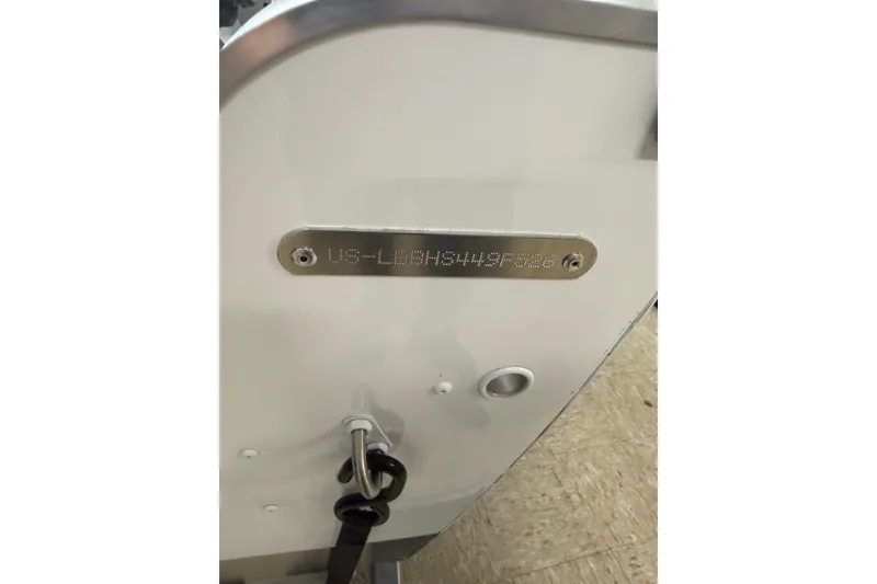 Slide: The Image of 2026 Lund 1600 Fury Tiller boat hull identification number plate. - 16