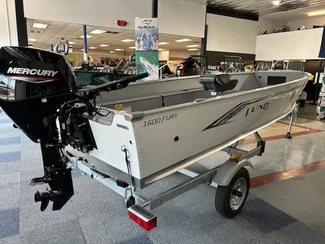 Slide: The Image of 2026 Lund 1600 Fury Tiller boat with Mercury engine on display in showroom. - 2